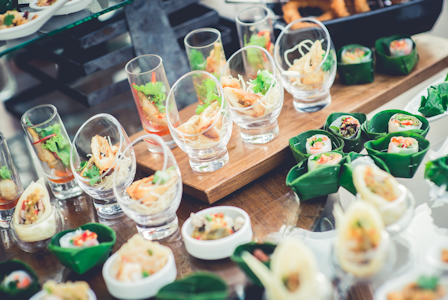 A table covered in glasses containing a Thai dish.