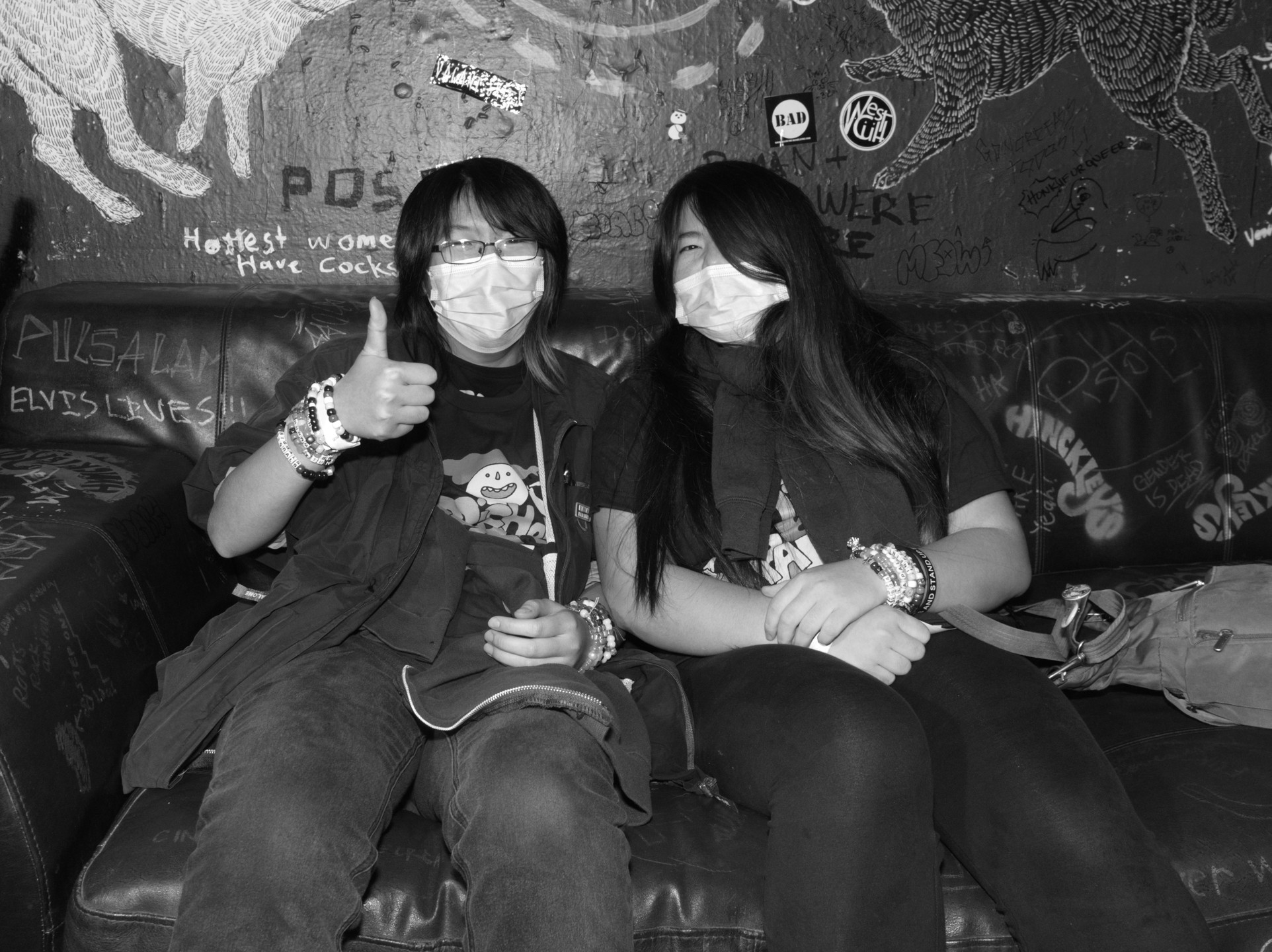 Celina and a friend sitting on a couch at 924 Gilman in Berkeley.